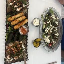 Gyro platter and Tapas plate spicy Turkish rice, feta cheese rolls, grape leafs, and hummus Gyro platter and Tapas plate spicy Turkish rice, feta cheese rolls, grape leafs, and hummus
