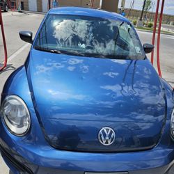 Super Star Car Wash - Telluride St & Green Valley Ranch Blvd - Blue Volkswagen Beetle cleaned after hail damage