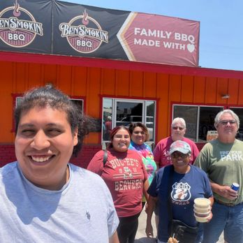 Bensmokin BBQ - Front of the restaurant with family - Caterers Near Me Bensmokin BBQ - Front of the restaurant with family - Caterers Near Me