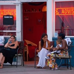 Me Reading a Lovely Client on the Asbury park boardwalk at Madam Marie's temple of knowledge