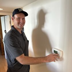 Wise Owl Cooling and Heating - The owner Nate Abell demonstrating the thermostat operation.