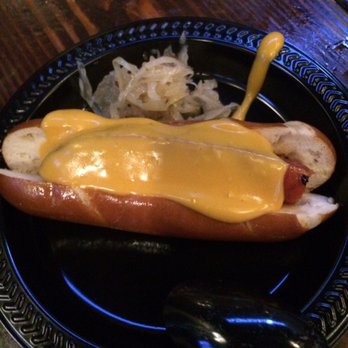 San Antonio FoodK - Sausage on pretzel bun with beer cheese sauce from Bier Garten - Local Flavor Near Me San Antonio FoodK - Sausage on pretzel bun with beer cheese sauce from Bier Garten - Local Flavor Near Me