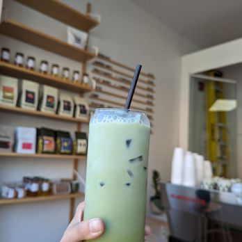 Issho Bakery - a hand holding a green drink - Bakeries Near Me - Toronto, Ontario