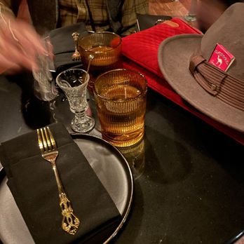 Tiger Bar - a man setting a table with a hat and glasses - Speakeasies Near Me - Nashville, Tennessee Tiger Bar - a man setting a table with a hat and glasses - Speakeasies Near Me - Nashville, Tennessee