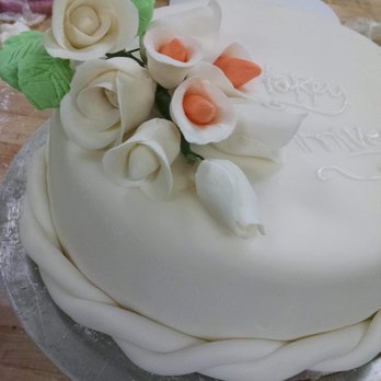 Tieredrose - a white cake on a table - Desserts Near Me Tieredrose - a white cake on a table - Desserts Near Me