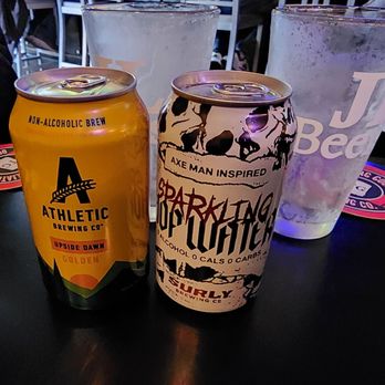 JL Beers - two cans of beer and a glass of water - Burgers Near Me - Sioux Falls, South Dakota