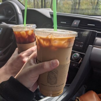 Imprint Coffee Roasting - a hand holding two cups of coffee - Coffee Roasteries Near Me - Sodus, New York