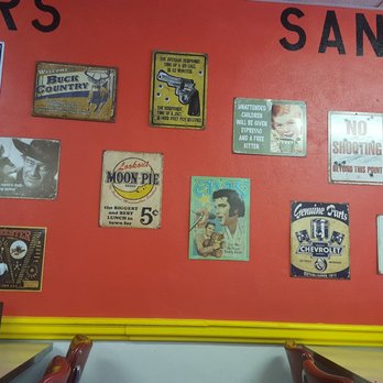 Lolly's - a red wall covered in posters - Pizza Near Me - McLean, Texas Lolly's - a red wall covered in posters - Pizza Near Me - McLean, Texas