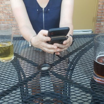 Roger's - a woman using her cell phone - Bars Near Me - Knoxville, Tennessee Roger's - a woman using her cell phone - Bars Near Me - Knoxville, Tennessee
