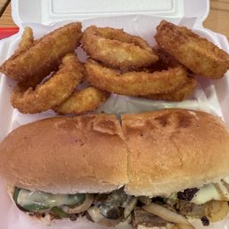 Onion rings and cheese steak sandwich.