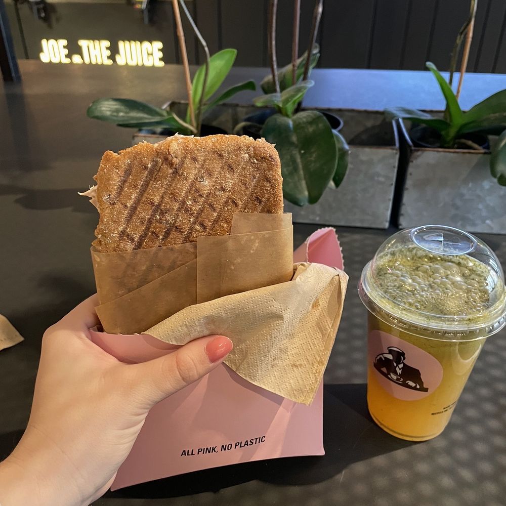 JOE & THE JUICE - a person holding a sandwich and a drink - Coffee & Tea Near Me - Washington, DC, District of Columbia