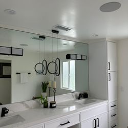 Top Voltage - Recessed lighting and in-ceiling speakers installed for seamless audio and clean modern bathroom design.
