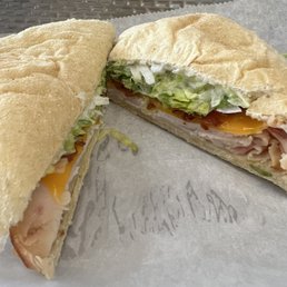Half turkey bacon ranch sandwich on white bread with lettuce and onion. Half turkey bacon ranch sandwich on white bread with lettuce and onion.
