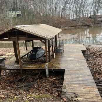 Dempsey Boys Lawn Care - a wooden dock with a boat on it - Lawn Services Near Me - Athens, Alabama Dempsey Boys Lawn Care - a wooden dock with a boat on it - Lawn Services Near Me - Athens, Alabama