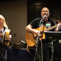 Baltimore Science Fiction Society - Two musicians, one with long white hair and a drum, one with a beard and a guitar.