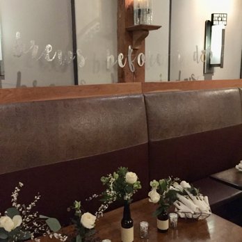 Table & Tulip - Beer bottle centerpieces w votives ran the length of the table. - Florists Near Me - Boston, Massachusetts