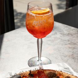 Speck Pizza + Street Food - A spritz from our bar and a wood-fired pizza waiting below. Pull up a seat, order a drink, and stay a while.