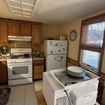 Skyline Remodeling - a kitchen with a stove, microwave, and refrigerator - General Contractors Near Me Skyline Remodeling - a kitchen with a stove, microwave, and refrigerator - General Contractors Near Me
