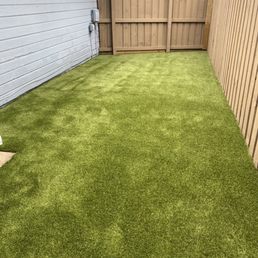 a backyard with artificial grass