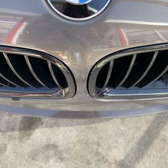 Rapids Express - Damages: residue and brush strokes left by tunnel equipment; chipped bumper cover; damaged grille - Car Wash Near Me - Anaheim, California