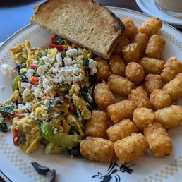 Greek scramble with a side of tater tots and sourdough toast.