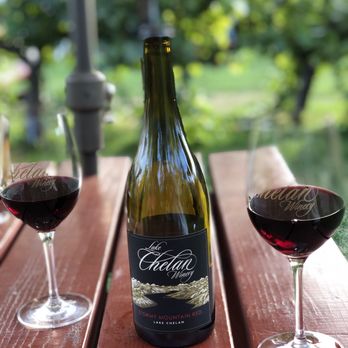 Lake Chelan Winery - a bottle of wine and two glasses of wine - Wineries Near Me - Chelan, Washington