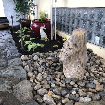 Pine Ridge Landscaping - a tree stump in a rock garden - Landscaping Near Me Pine Ridge Landscaping - a tree stump in a rock garden - Landscaping Near Me