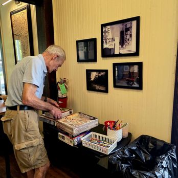 The Traveler - A patron looking at the board games and puzzles - Coffee & Tea Near Me - Ocean Springs, Mississippi The Traveler - A patron looking at the board games and puzzles - Coffee & Tea Near Me - Ocean Springs, Mississippi