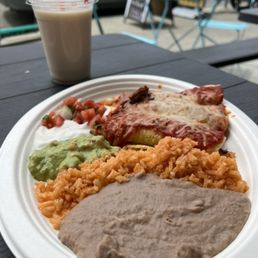 Enchilada platter served with rice and refried pinto beans. The enchiladas were filled with the al-pastor beef spiced just right.