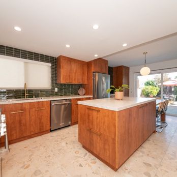 Adar Roofing & Construction - Open kitchen remodel featuring quartz island, warm cabinets and natural light for a modern clean design. - Roofing Near Me - Winnetka, California