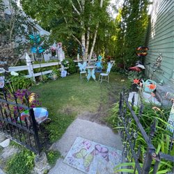 My Front Porch - The beautiful side garden; artist meet and greets are held here and all kinds of yard art that's for sale through the shop.