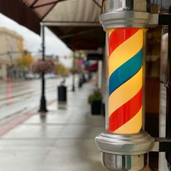 White Swan Barber Shop - Glowing barber pole on a rainy Wyoming morning.