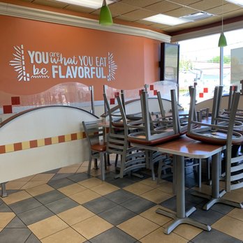 Pollo Campero - a table and chairs in a restaurant - Fast Food Near Me - Huntington, New York