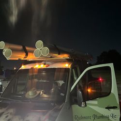 Rushmore Plumbing - Fleet vehicle lighting up the night