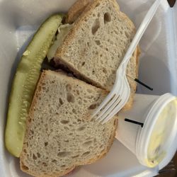Davids New York Deli - Corned beef Dinty Moore Sandwich with potato salad and a pickle.