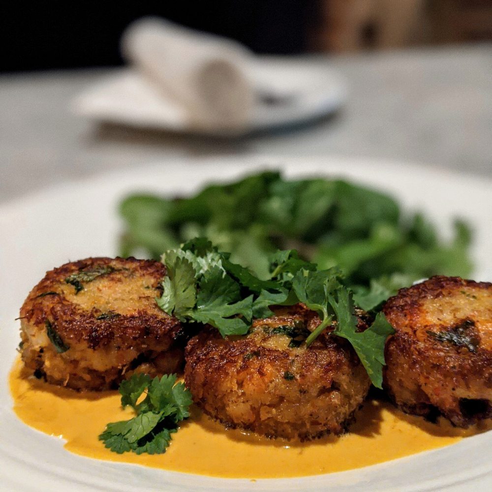 Mizuna - Ginger Jalapeno Crab Cakes over coconut curry sauce - New American Near Me - Spokane, Washington