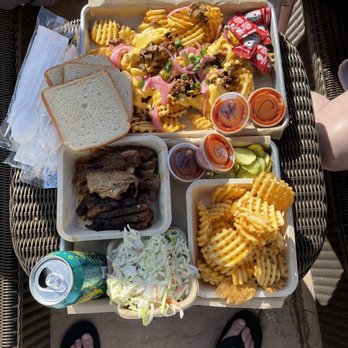 Backyard Bar & BBQ - a table full of food - Barbeque Near Me - Truckee, California
