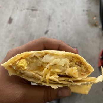 Norm's Hamburger - a person holding a sandwich - Burgers Near Me - Burbank, California Norm's Hamburger - a person holding a sandwich - Burgers Near Me - Burbank, California