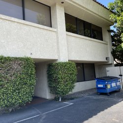Cosmic Speech Therapy - Back of office building, where the parking lot is. Suite is located at top right corner.