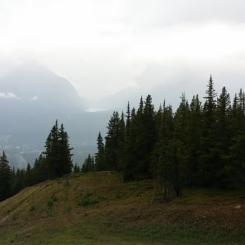 Banff National Park - Lake Louise in between the mountains (look through the fog) - Parks Near Me - Banff, Alberta Banff National Park - Lake Louise in between the mountains (look through the fog) - Parks Near Me - Banff, Alberta