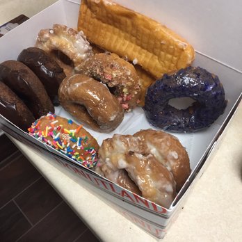 Donutland - The dozen doughnuts we got the one on the upper right corner is the blueberry one. - Donuts Near Me - Cedar Rapids, Iowa
