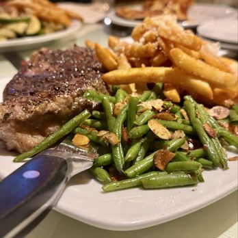 ROAM Cafe - Strip steak with Garlic Parmesan Fries and green beans with almonds - New American Near Me - Rochester, New York ROAM Cafe - Strip steak with Garlic Parmesan Fries and green beans with almonds - New American Near Me - Rochester, New York