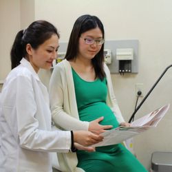 Charles B. Wang Community Health Center - A CBWCHC OB/GYN provider discusses prenatal care with a patient.