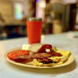 Ross's Diner - Veggie omelet with grits, bacon and slides tomatoes.