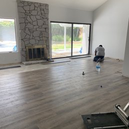 a man sitting on a hard wood floor