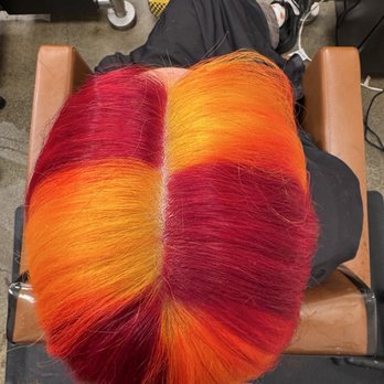 The Colour Bar Salon - Top-down view of hair dyed red and yellow. - Hair Salons Near Me - Sacramento, California The Colour Bar Salon - Top-down view of hair dyed red and yellow. - Hair Salons Near Me - Sacramento, California