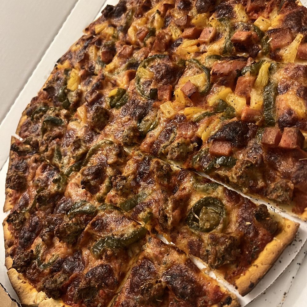 Dough Daddy's Pizza - Half and half.  Left: candied jalapeño and house made sausage  Right: Mowie Wowie (spam + pineapple) - Pizza Near Me - Westmont, Illinois