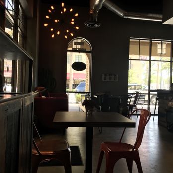 ANTHEM Coffee & Tea | Verrado - a few of the tables and the big red couch - Coffee & Tea Near Me - Buckeye, Arizona