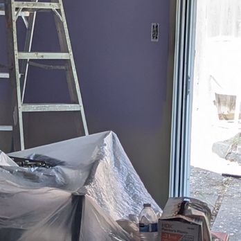 Gjp  painting and construction - You can see the brass shelves in the left on the bed, and he's using the antique piece of furniture on the right as a work table. - Painters Near Me