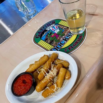 Gators Dockside - Lake Nona - a glass of white wine and a plate of food - Sports Bars Near Me - Lake Nona, Florida Gators Dockside - Lake Nona - a glass of white wine and a plate of food - Sports Bars Near Me - Lake Nona, Florida